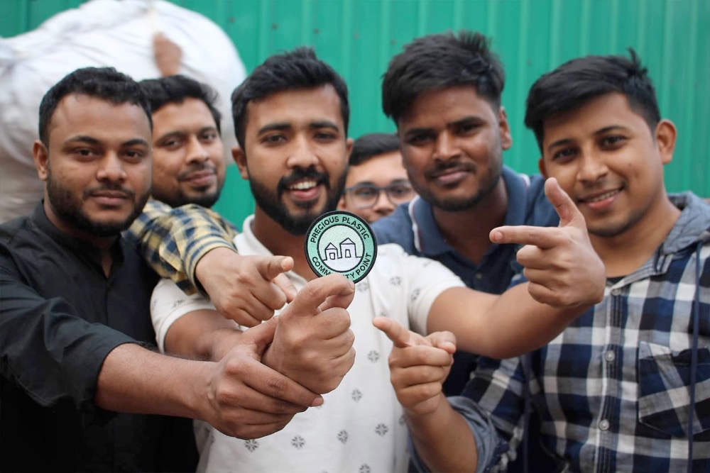 Bangladesh men holding a badge