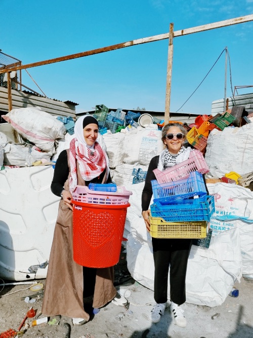 Two women recycling plastic in a recycling facility