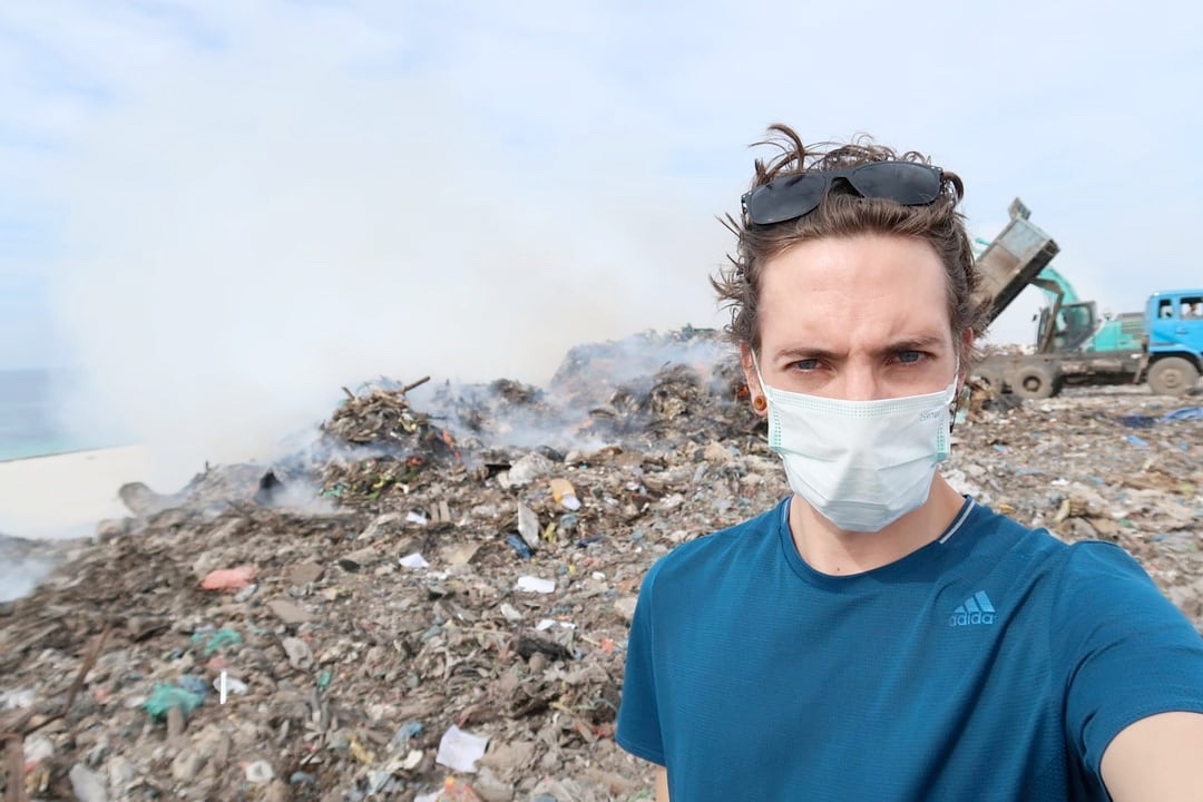 man in a open dumpsite
